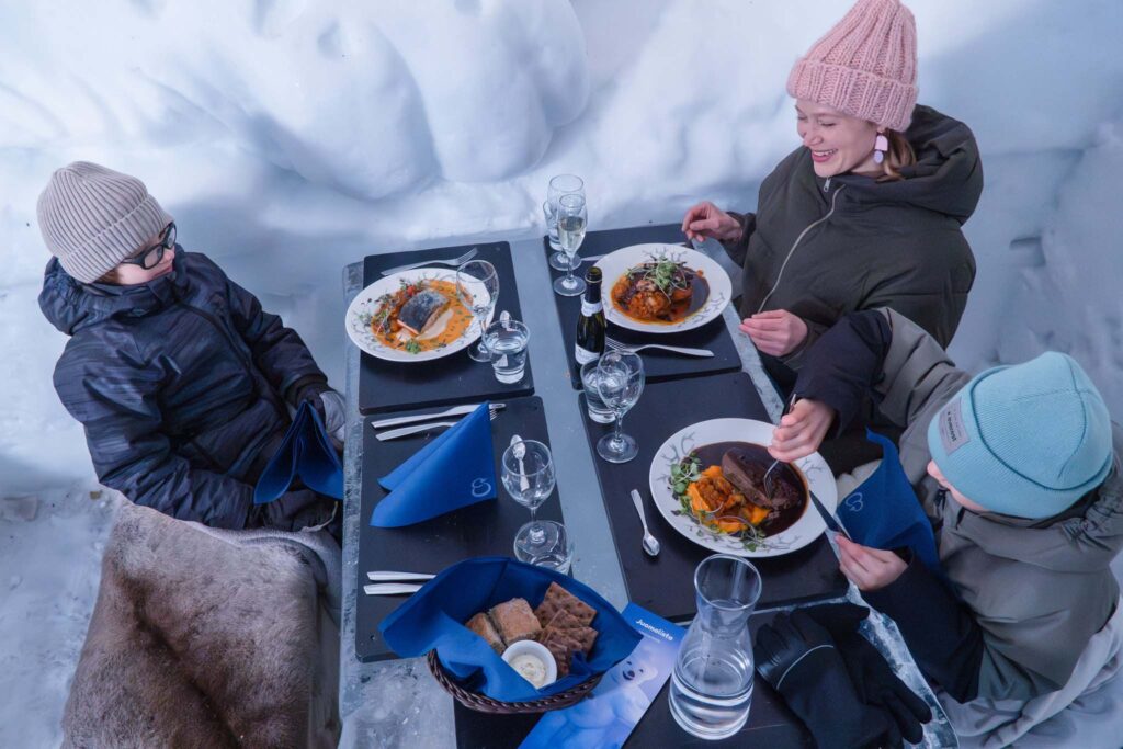 A family enjoying a dinner in the Snow Restaurant in Santa Claus Village
