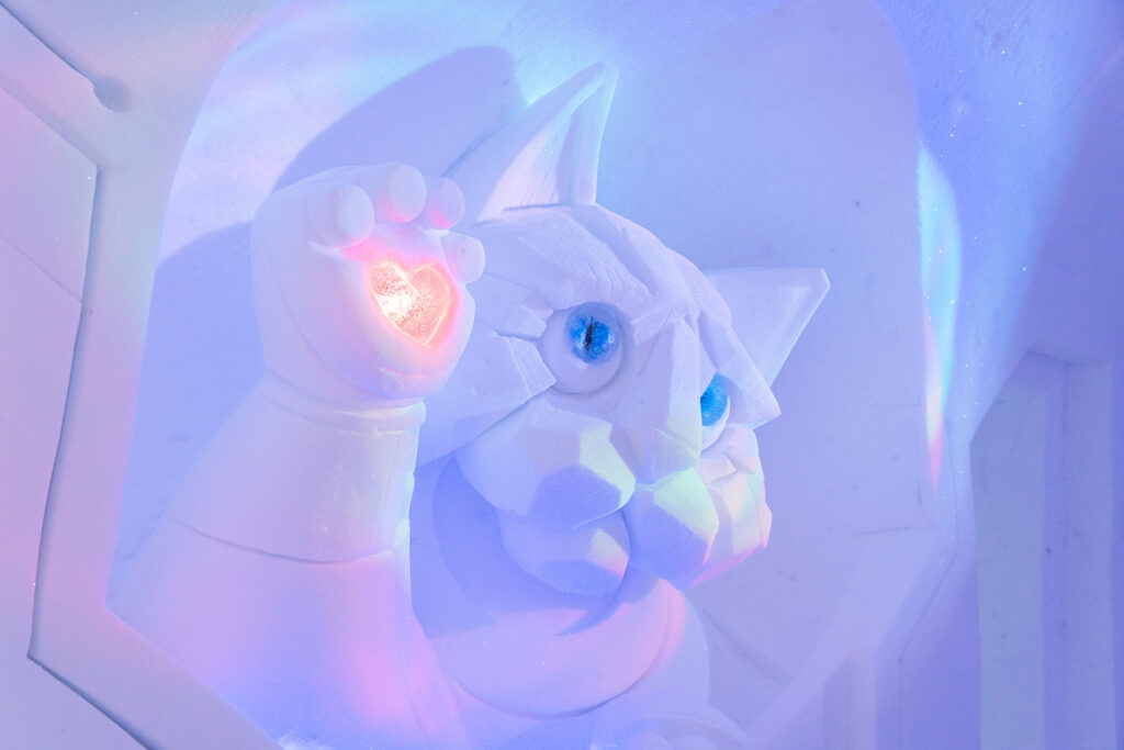 Snow art piece of a cyborg cat.