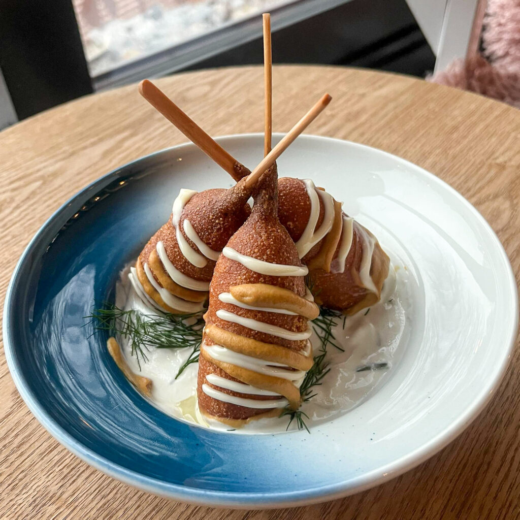 Corn dogs served with tzatziki sauce at Café Ensilumi.